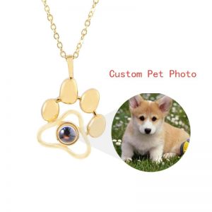 a dog and a gold paw necklace