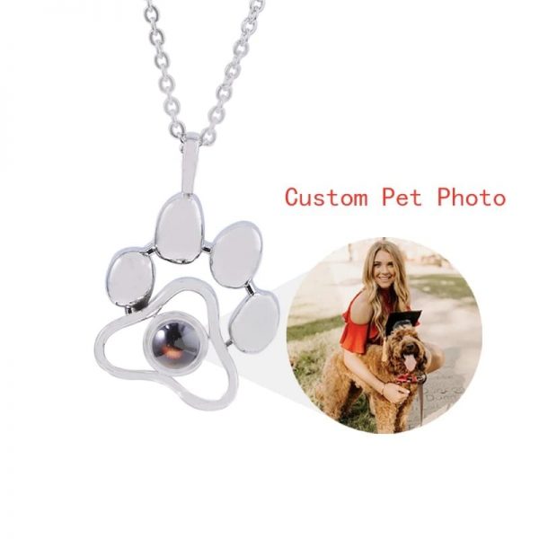 a woman with a dog and a paw necklace