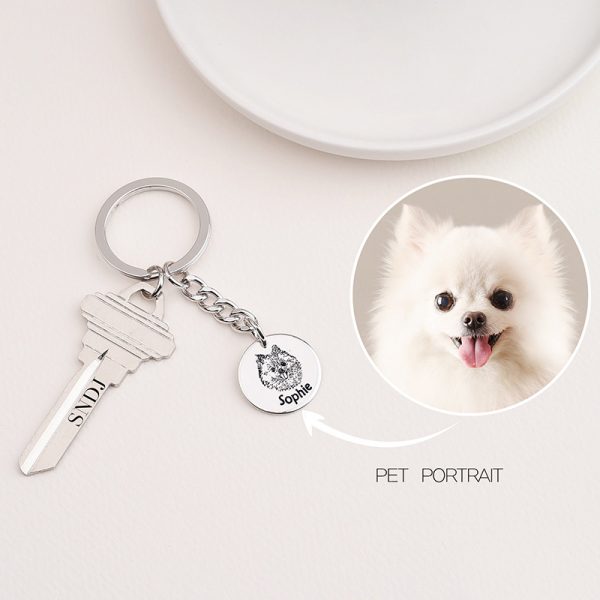 a silver pet portrait keychain and a dog photo