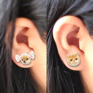 a woman wear hand painted pet photo earrings