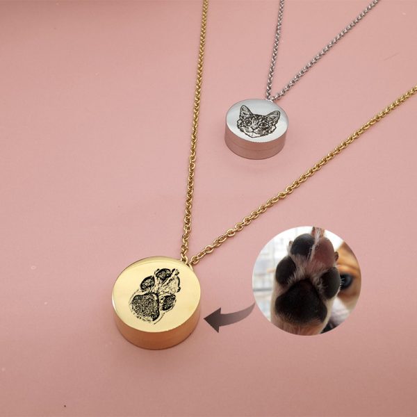 one silver pet urn necklace and paw print necklace