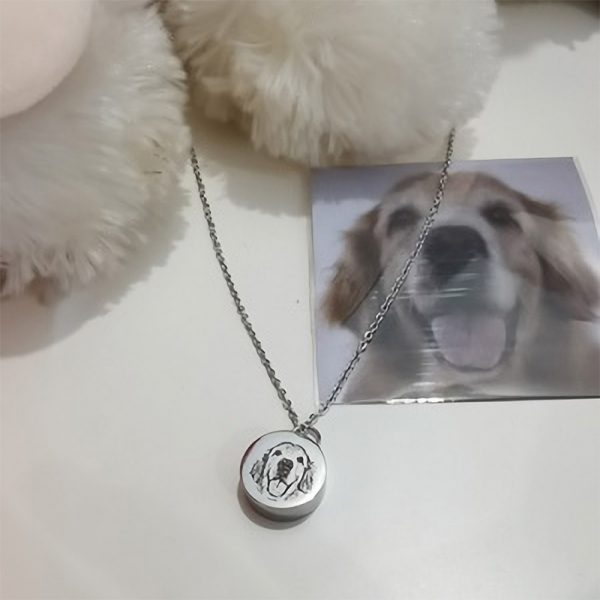 a dog photo and a silver pet urn necklace